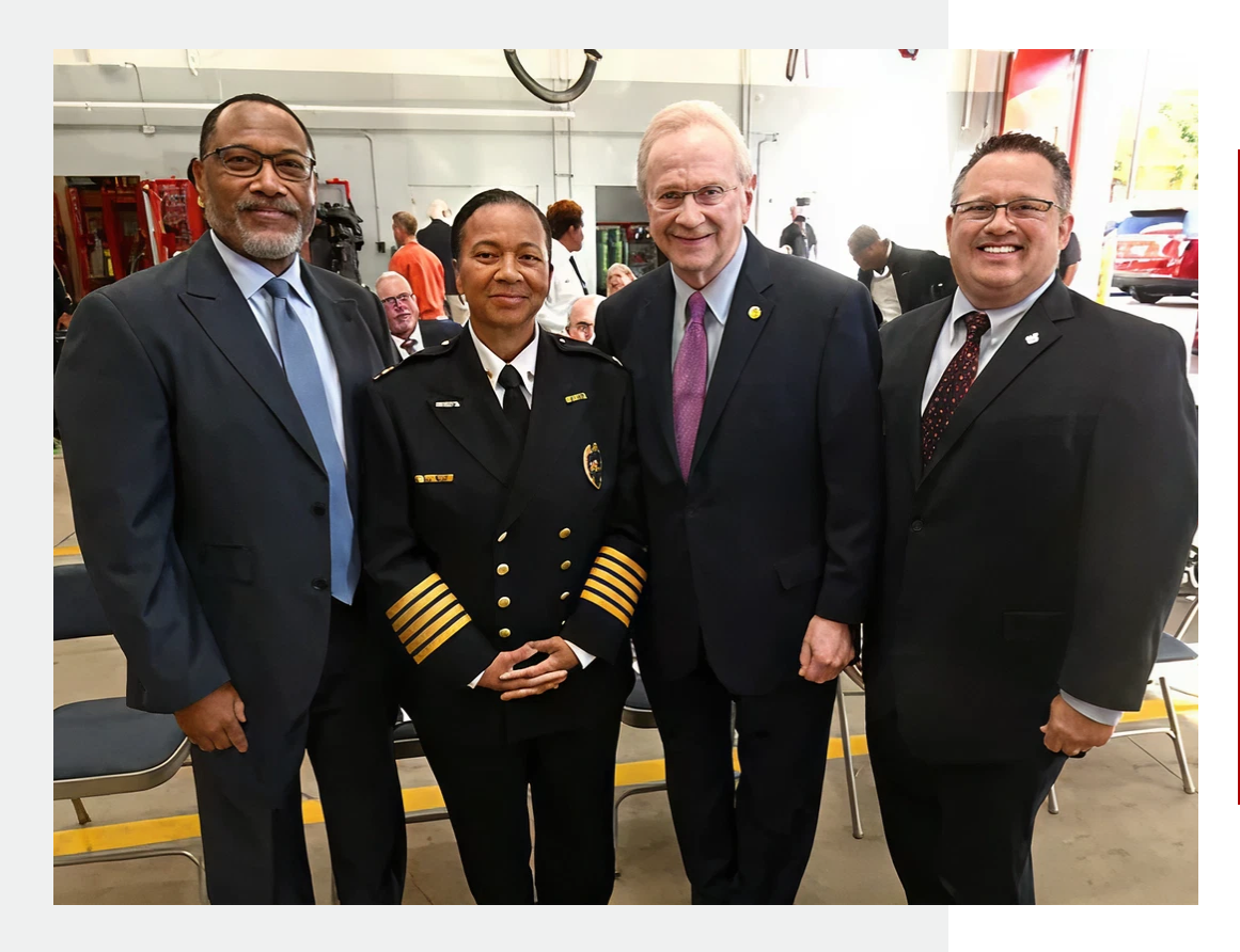Four professionals posing together indoors